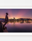 Solace in the Wind sculpture overlooking Wellington Harbour at dusk, displayed in a white frame with a white mat.